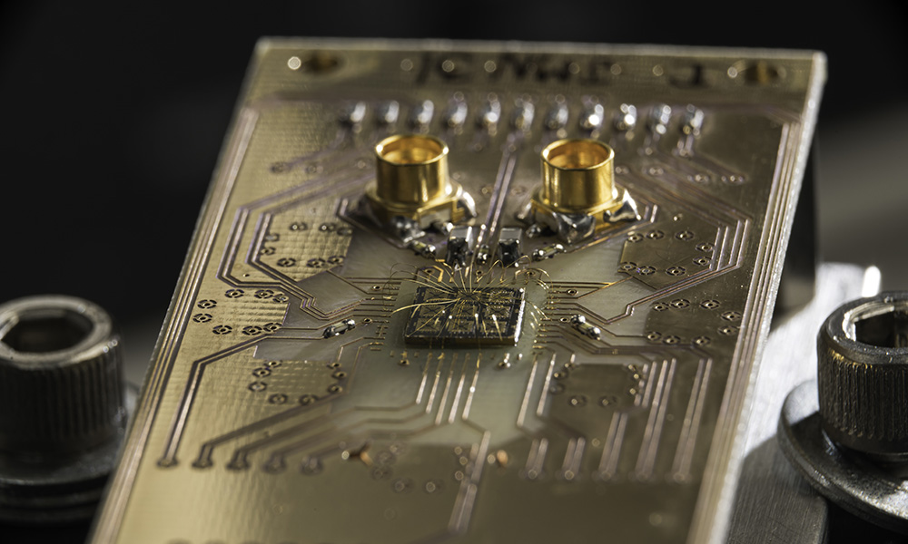 quantum processor semiconductor chip connected to a circuit board.
