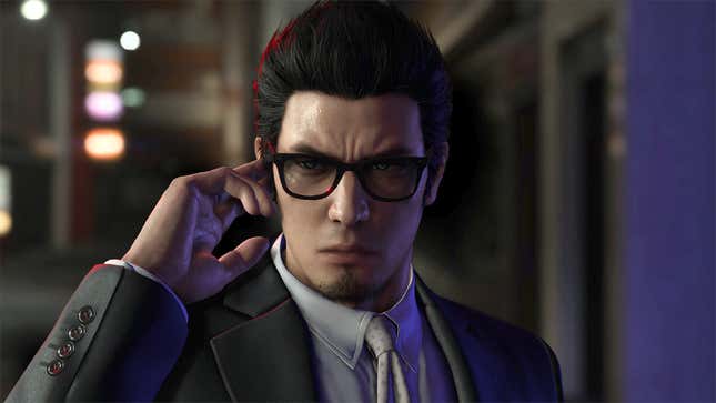 A suited Yakuza character stands in front of the camera, their finger touching the right side of their glasses.
